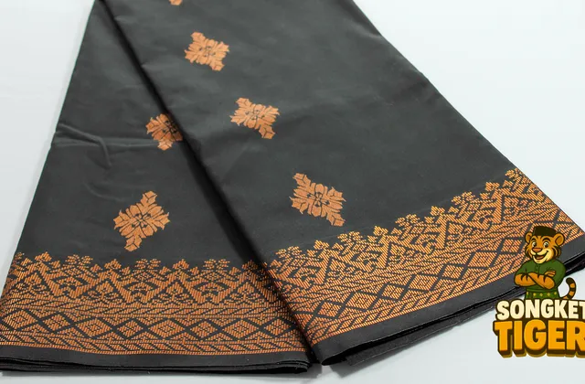 Songket fabric in deep maroon with gold thread motifs