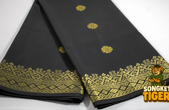 Close-up of songket fabric showing gold thread motifs woven into the cloth