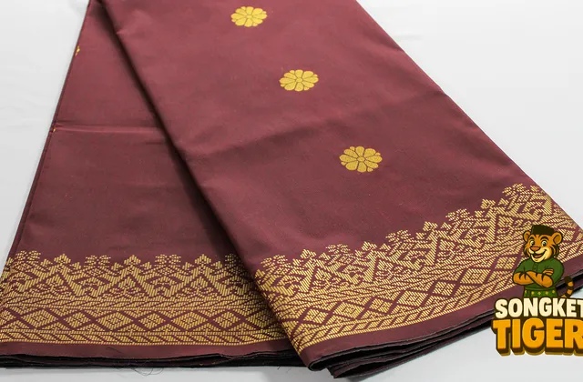 Folded songket fabric with intricate gold woven border detail