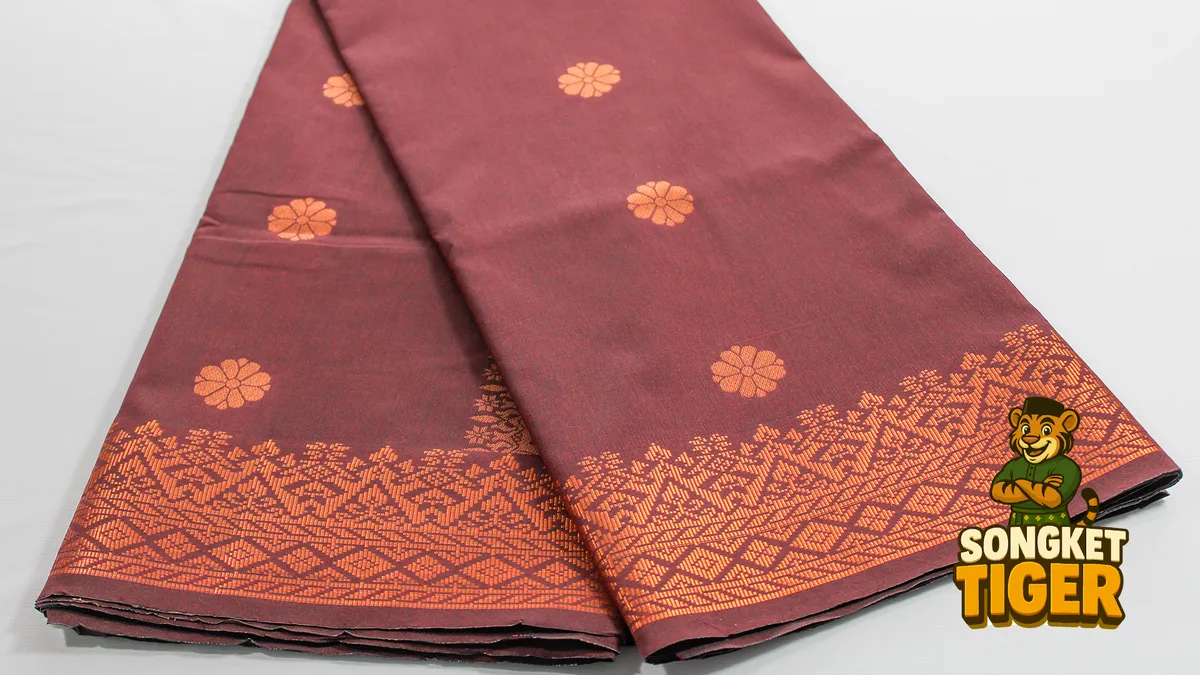Detailed view of a repeating gold songket pattern woven across black fabric