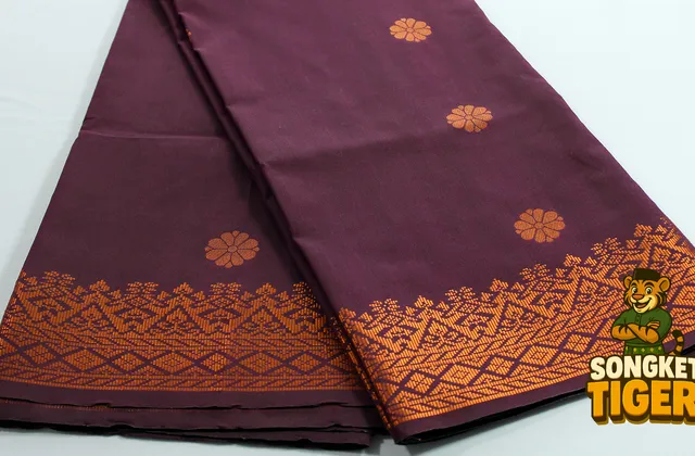 Traditional songket fabric with dense gold motif weaving in classic layout