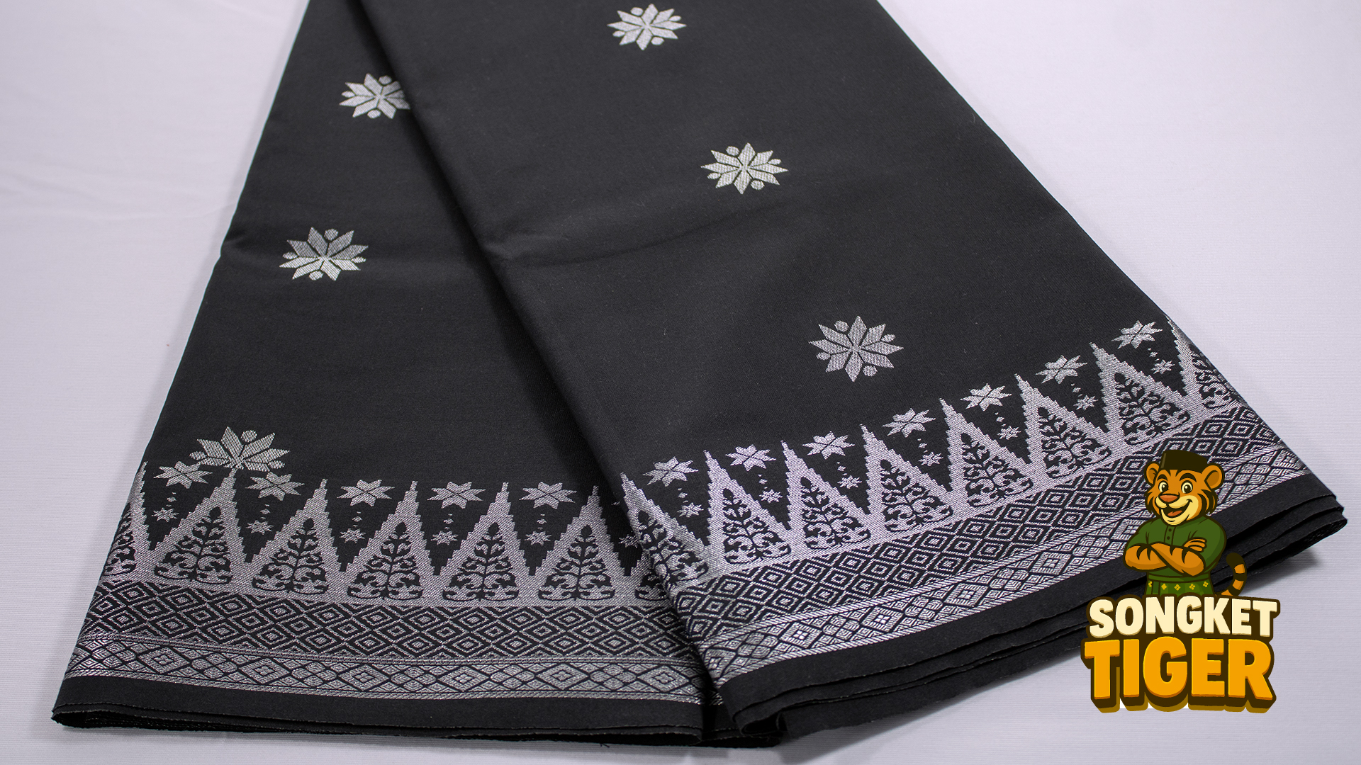 Gold-threaded songket with layered border patterns