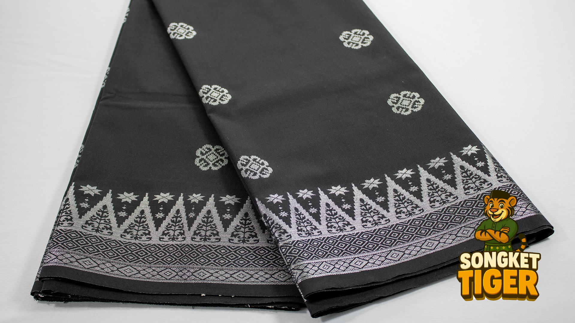 Brown songket with tribal-inspired geometric border